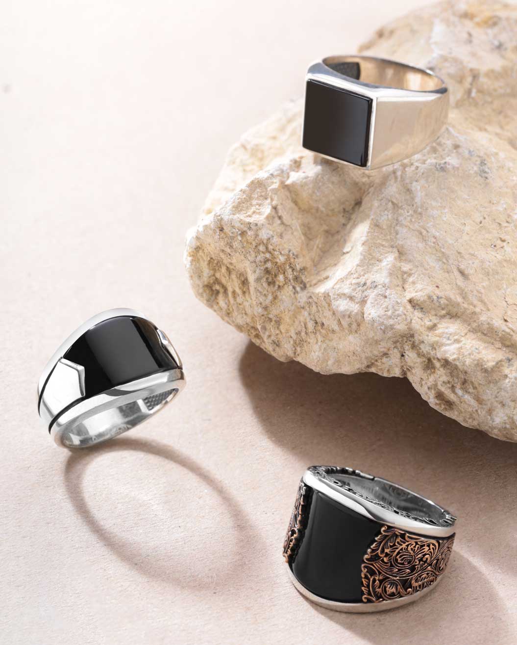 Elegant black onyx rings in various styles including solitaire, signet, art deco, and minimalist designs set in silver